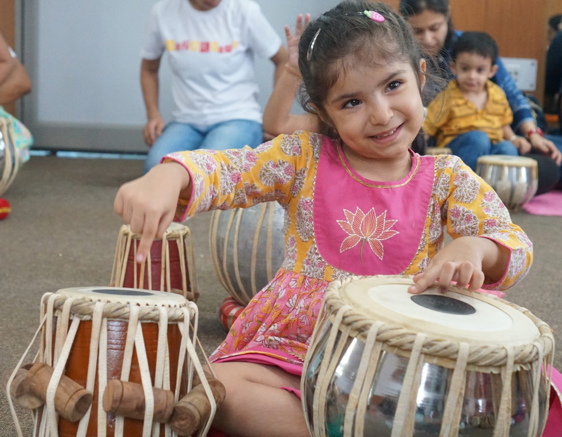 Three-year-old children participating in a music class in Dubai with instruments and movement activities