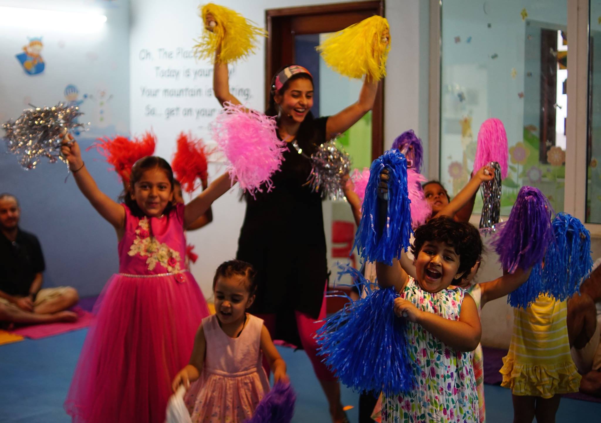Toddlers enjoying music and movement classes in Dubai with instruments and dance activities