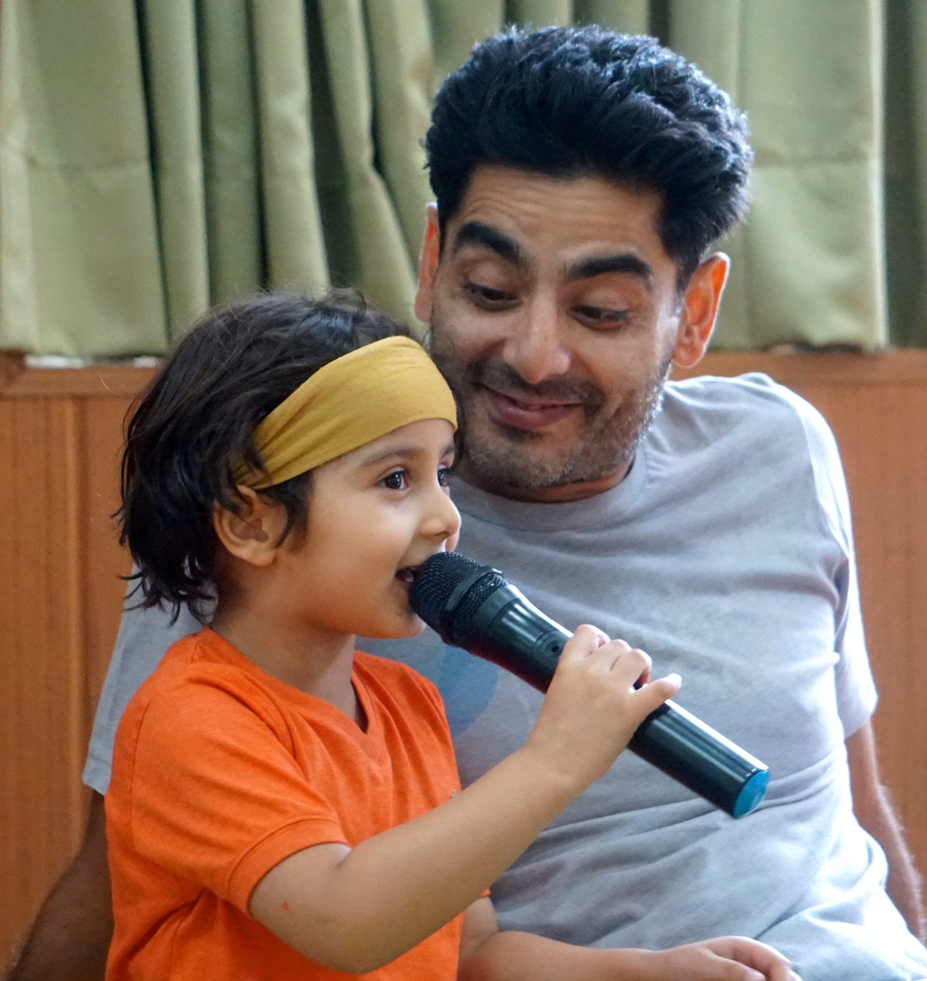 Parent supporting child during music practice at home after kids music classes in JLT